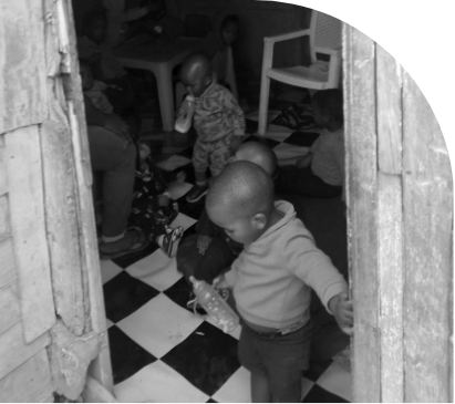 Toddlers playing together in a bright, checkered room.